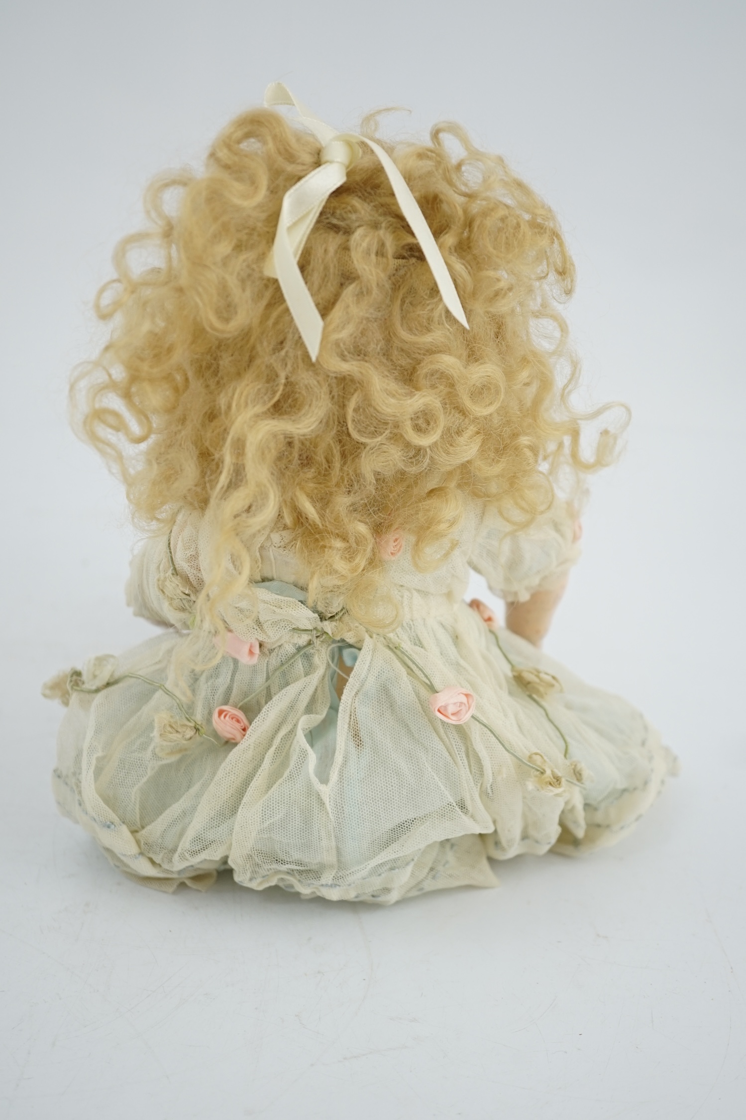 A Kammer & Reinhart / S & H bisque head doll, pierced ears, vintage clothes, one finger missing, slight rub to robe, 34cm